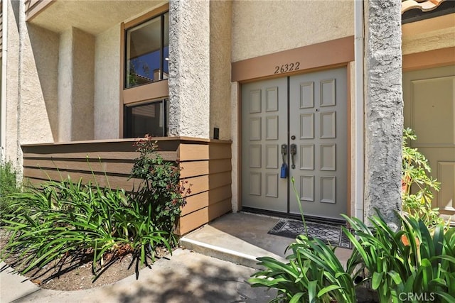 26322 W Bravo Ln, Calabasas, CA 91302 - doorway to property with stucco siding