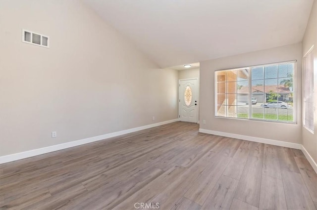 27541 Vanilla Ct, Menifee, CA 92585 - unfurnished living room featuring wood finished floors, baseboards, and vaulted ceiling