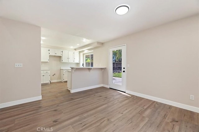 27541 Vanilla Ct, Menifee, CA 92585 - unfurnished living room with light wood finished floors, baseboards, and recessed lighting