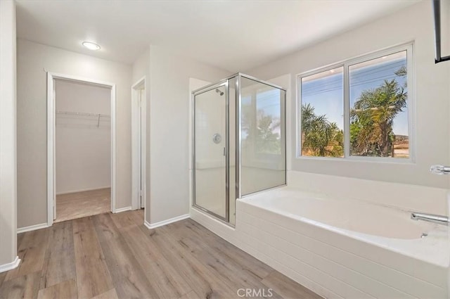 27541 Vanilla Ct, Menifee, CA 92585 - bathroom with a shower stall, a garden tub, wood finished floors, and a walk in closet