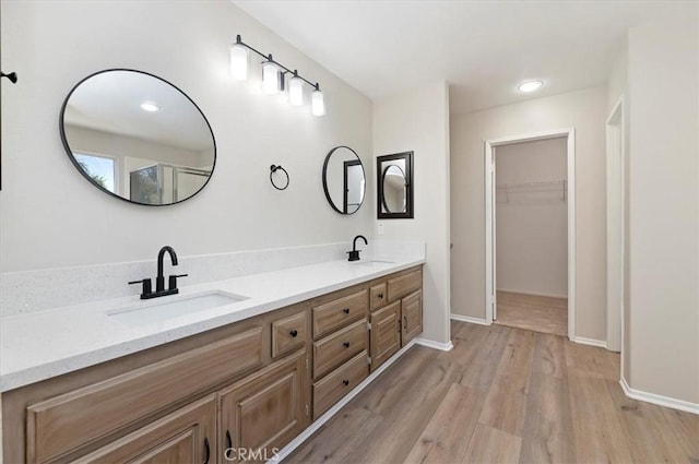 27541 Vanilla Ct, Menifee, CA 92585 - full bath featuring double vanity, wood finished floors, a walk in closet, and baseboards