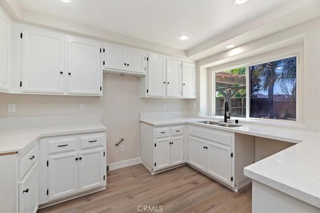 27541 Vanilla Ct, Menifee, CA 92585 - kitchen with a sink, white cabinets, light wood-type flooring, and recessed lighting