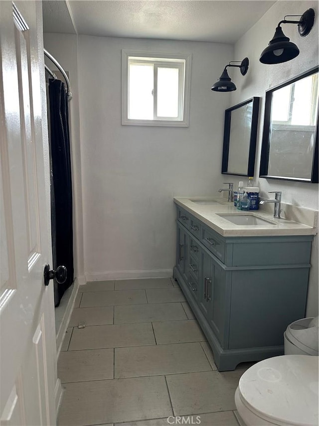 52068 Hattie Ave, Cabazon, CA 92230 - full bathroom with toilet, double vanity, tile patterned floors, and curtained shower