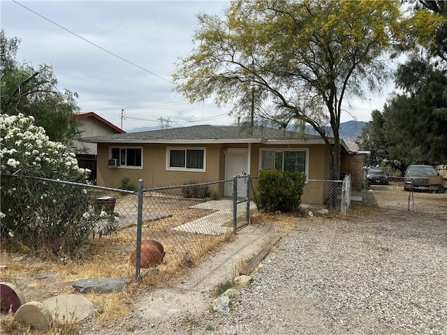 52068 Hattie Ave, Cabazon, CA 92230 - ranch-style home featuring stucco siding, a fenced front yard, and roof with shingles