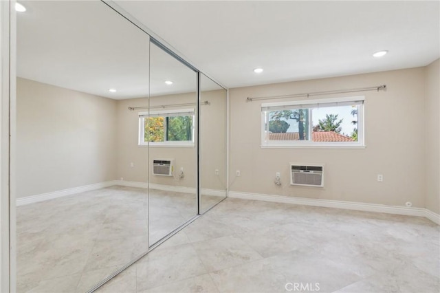 879 Via Mendoza Unit B, Laguna Woods, CA 92637 - unfurnished bedroom with a wall unit AC, recessed lighting, a closet, baseboards, and tile patterned floors
