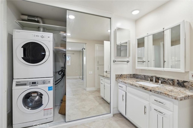 879 Via Mendoza Unit B, Laguna Woods, CA 92637 - washroom featuring stacked washer and clothes dryer, light tile patterned floors, and recessed lighting