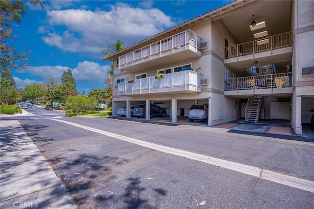 879 Via Mendoza Unit B, Laguna Woods, CA 92637 - view of apartment building / complex featuring covered parking