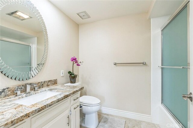 879 Via Mendoza Unit B, Laguna Woods, CA 92637 - full bath featuring vanity, toilet, baseboards, combined bath / shower with glass door, and tile patterned flooring