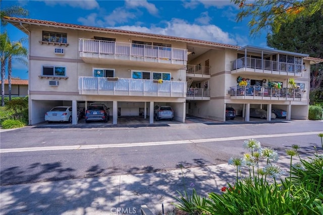 879 Via Mendoza Unit B, Laguna Woods, CA 92637 - view of apartment building / complex featuring covered parking