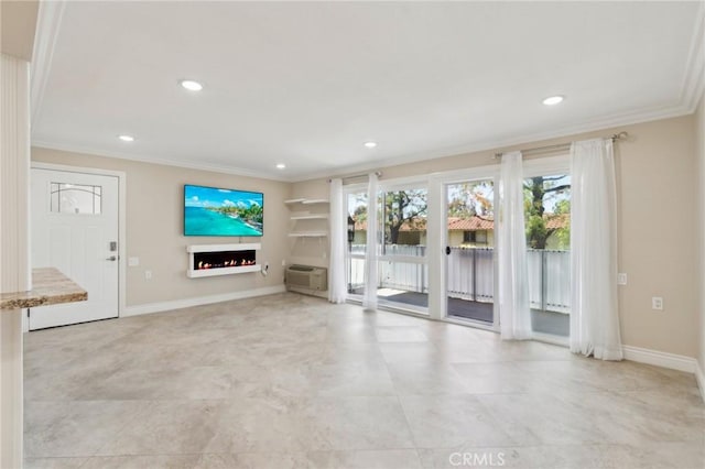 879 Via Mendoza Unit B, Laguna Woods, CA 92637 - unfurnished living room featuring a warm lit fireplace, ornamental molding, recessed lighting, a wall unit AC, and baseboards