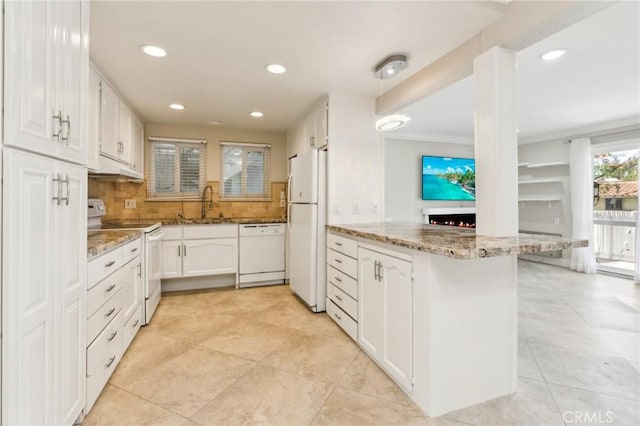879 Via Mendoza Unit B, Laguna Woods, CA 92637 - kitchen with white appliances, a peninsula, white cabinets, light stone counters, and recessed lighting