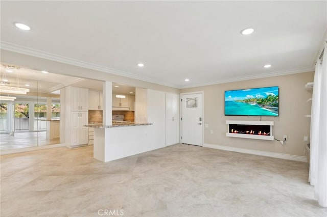 879 Via Mendoza Unit B, Laguna Woods, CA 92637 - unfurnished living room featuring a lit fireplace, ornamental molding, and recessed lighting
