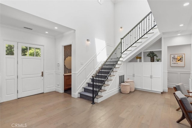 3914 Woodfield Dr, Sherman Oaks, CA 91403 - foyer entrance featuring a decorative wall, crown molding, stairs, light wood-type flooring, and recessed lighting