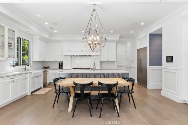 3914 Woodfield Dr, Sherman Oaks, CA 91403 - dining room with a chandelier, light wood finished floors, crown molding, a wainscoted wall, and recessed lighting