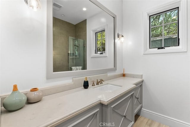 3914 Woodfield Dr, Sherman Oaks, CA 91403 - bathroom featuring vanity, healthy amount of natural light, a tile shower, and wood finished floors