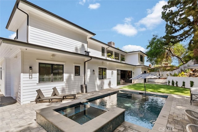 3914 Woodfield Dr, Sherman Oaks, CA 91403 - back of property featuring a patio area, a pool with connected hot tub, and a chimney
