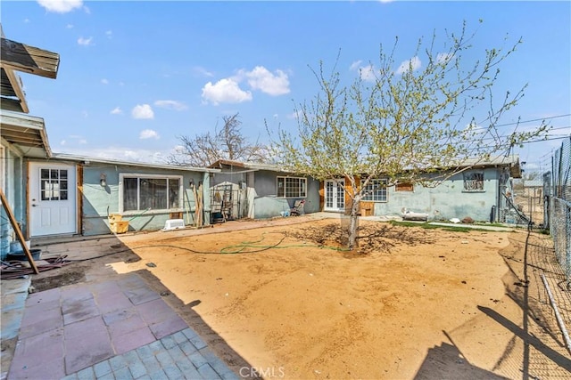 26447 20 Mule Team Rd, Boron, CA 93516 - rear view of house with french doors, stucco siding, and a patio area