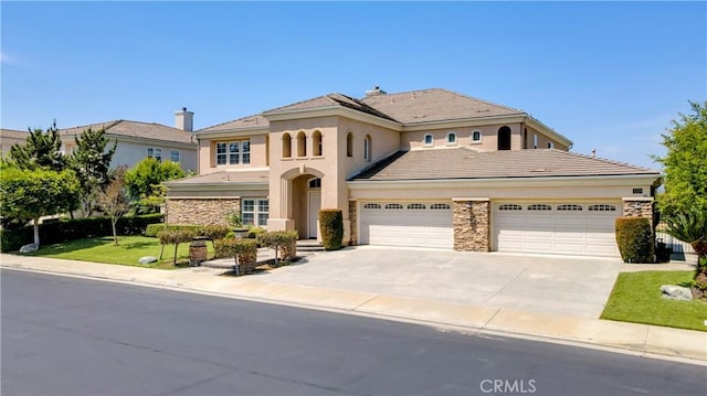 2225 Wind River Ln, Rowland Heights, CA 91748 - mediterranean / spanish-style house with stone siding, concrete driveway, and stucco siding