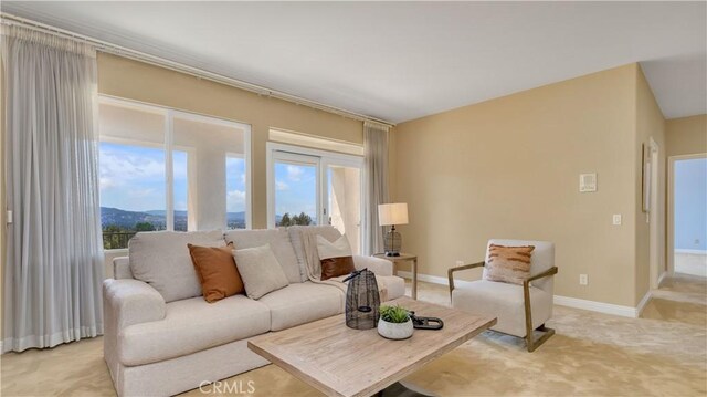 2225 Wind River Ln, Rowland Heights, CA 91748 - living area featuring light carpet, plenty of natural light, and baseboards