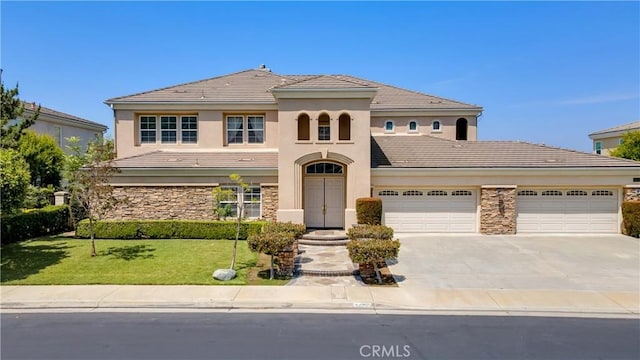 2225 Wind River Ln, Rowland Heights, CA 91748 - mediterranean / spanish-style house featuring a tile roof, a front lawn, driveway, a garage, and stone siding