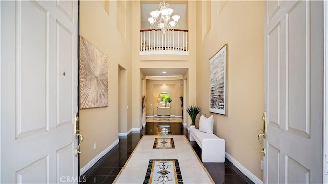 2225 Wind River Ln, Rowland Heights, CA 91748 - entryway with baseboards, a chandelier, dark tile patterned flooring, and a high ceiling