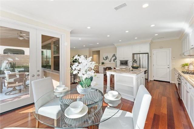 33 Lacebark, Irvine, CA 92618 - dining area with ornamental molding, dark wood finished floors, recessed lighting, a ceiling fan, and french doors