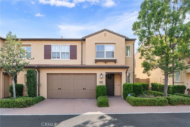 33 Lacebark, Irvine, CA 92618 - multi unit property featuring stucco siding, a garage, and decorative driveway