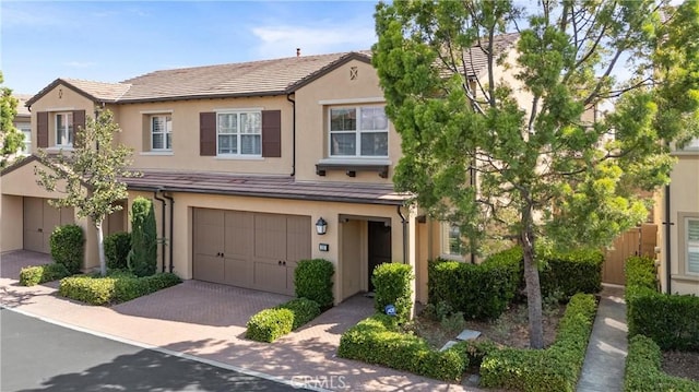 33 Lacebark, Irvine, CA 92618 - townhome / multi-family property with a garage, stucco siding, and decorative driveway