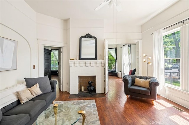 256 E 1st Ave, Chico, CA 95926 - living area featuring healthy amount of natural light, wood finished floors, a brick fireplace, and ceiling fan