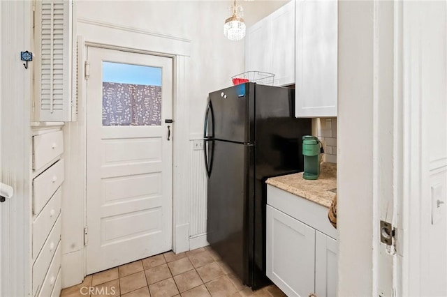 256 E 1st Ave, Chico, CA 95926 - kitchen with freestanding refrigerator, light tile patterned flooring, white cabinetry, and pendant lighting