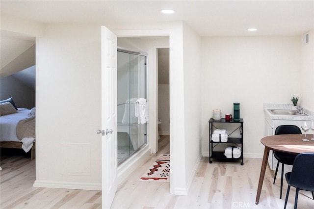 256 E 1st Ave, Chico, CA 95926 - ensuite bathroom featuring wood finished floors, a stall shower, recessed lighting, and vanity