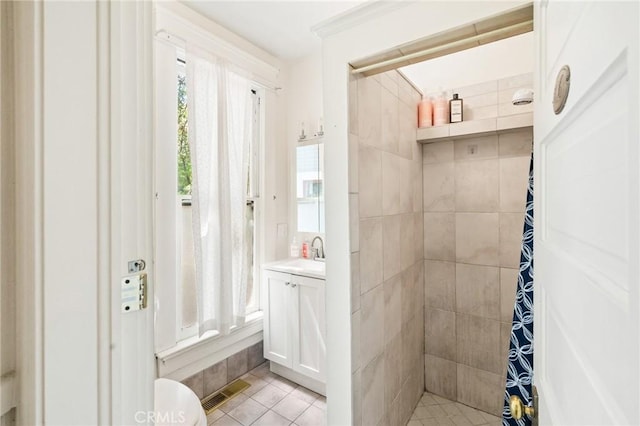 256 E 1st Ave, Chico, CA 95926 - bathroom with tiled shower, vanity, and tile patterned floors