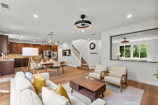 28321 Esplanada Dr, Valencia, CA 91354 - living area featuring stairway, recessed lighting, light wood finished floors, and baseboards