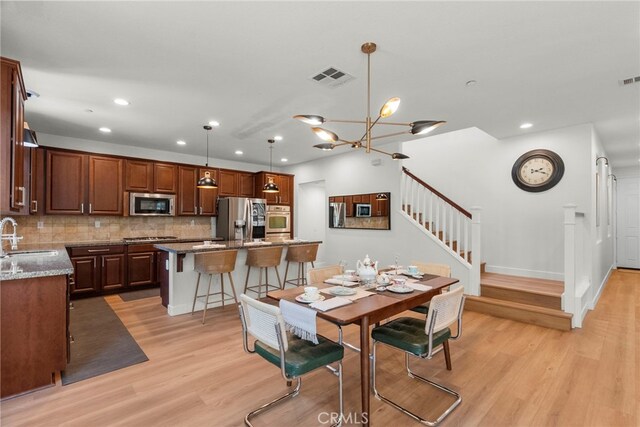 28321 Esplanada Dr, Valencia, CA 91354 - dining area with stairway, light wood-style floors, recessed lighting, and a chandelier