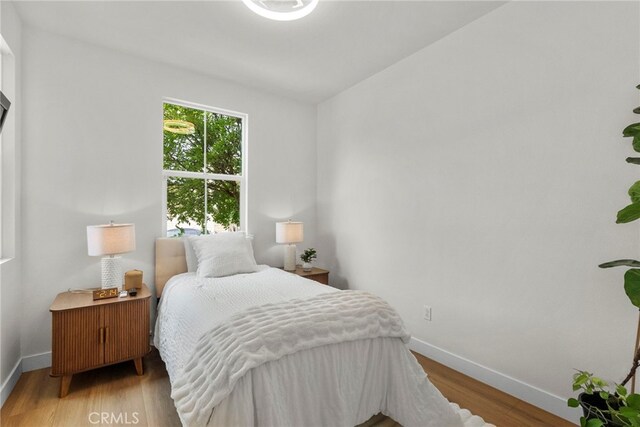 28321 Esplanada Dr, Valencia, CA 91354 - bedroom featuring baseboards and wood finished floors