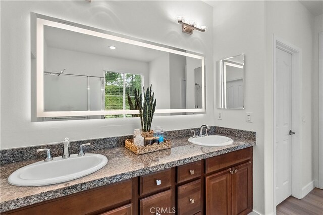 28321 Esplanada Dr, Valencia, CA 91354 - bathroom featuring double vanity and wood finished floors