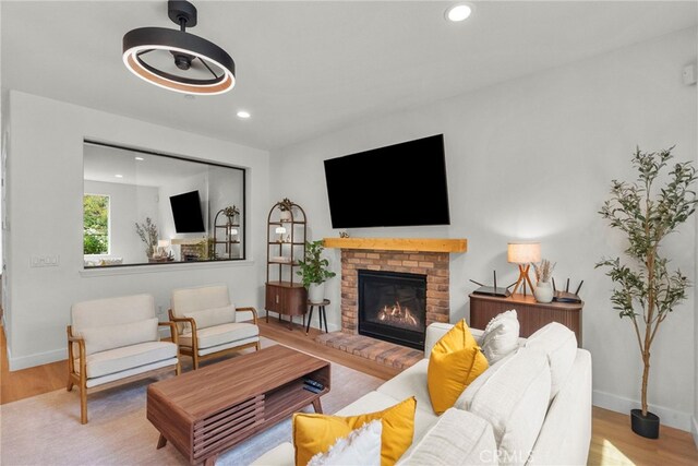 28321 Esplanada Dr, Valencia, CA 91354 - living room with wood finished floors, recessed lighting, a fireplace, and baseboards