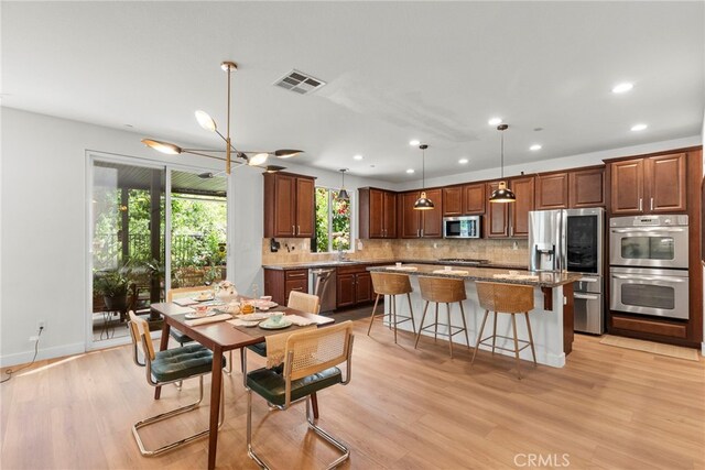 28321 Esplanada Dr, Valencia, CA 91354 - dining area featuring recessed lighting, light wood finished floors, a chandelier, and baseboards