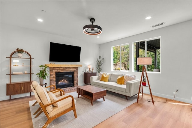 28321 Esplanada Dr, Valencia, CA 91354 - living area with light wood finished floors, recessed lighting, a brick fireplace, and baseboards