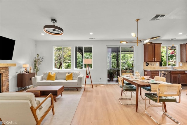 28321 Esplanada Dr, Valencia, CA 91354 - living room with healthy amount of natural light, light wood-type flooring, recessed lighting, a fireplace, and baseboards