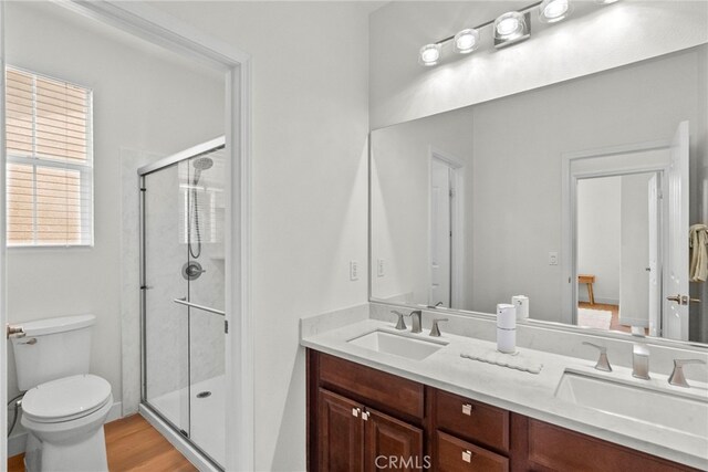 28321 Esplanada Dr, Valencia, CA 91354 - full bath featuring a stall shower, double vanity, toilet, and wood finished floors