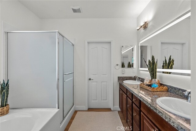 28321 Esplanada Dr, Valencia, CA 91354 - full bath with double vanity, a stall shower, a garden tub, and wood finished floors
