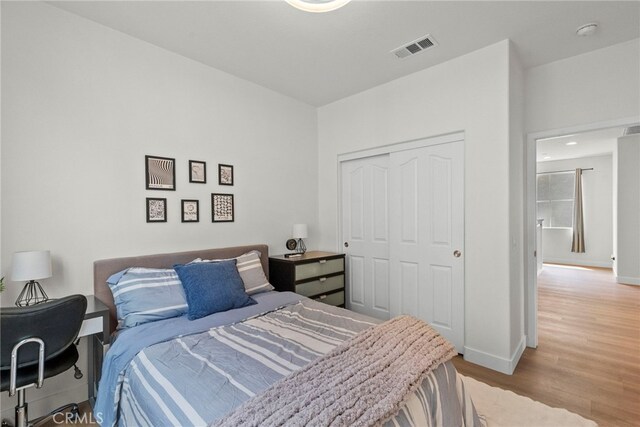 28321 Esplanada Dr, Valencia, CA 91354 - bedroom featuring light wood-style floors, a closet, and baseboards
