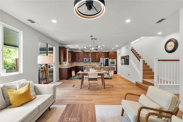 28321 Esplanada Dr, Valencia, CA 91354 - living room with light wood finished floors, recessed lighting, stairs, and baseboards