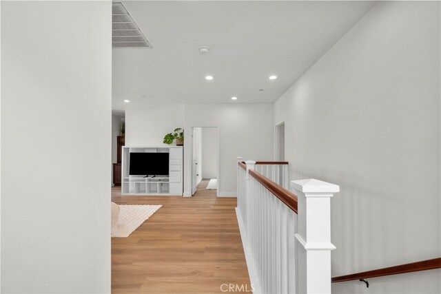 28321 Esplanada Dr, Valencia, CA 91354 - corridor featuring an upstairs landing, recessed lighting, and light wood-style flooring