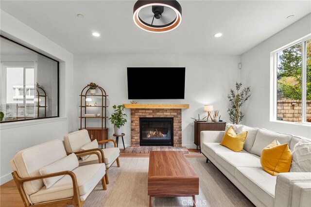 28321 Esplanada Dr, Valencia, CA 91354 - living area with light wood-style flooring, recessed lighting, a brick fireplace, and baseboards