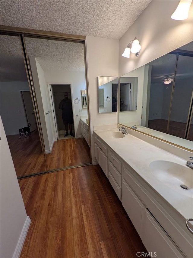 1266 Tarryglen Ln, San Dimas, CA 91773 - full bath with a textured ceiling, wood finished floors, double vanity, a tub, and a walk in closet