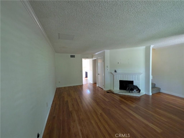 1266 Tarryglen Ln, San Dimas, CA 91773 - unfurnished living room with a textured ceiling, wood finished floors, a fireplace, crown molding, and baseboards