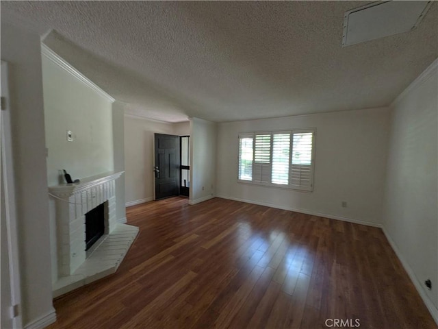 1266 Tarryglen Ln, San Dimas, CA 91773 - unfurnished living room with a textured ceiling, wood finished floors, a brick fireplace, baseboards, and crown molding