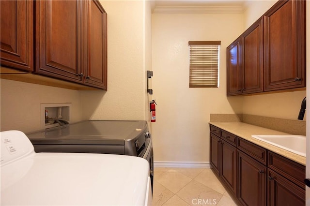 12920 Evermay Ct, Rancho Cucamonga, CA 91739 - laundry area featuring washing machine and clothes dryer, cabinet space, baseboards, ornamental molding, and light tile patterned floors